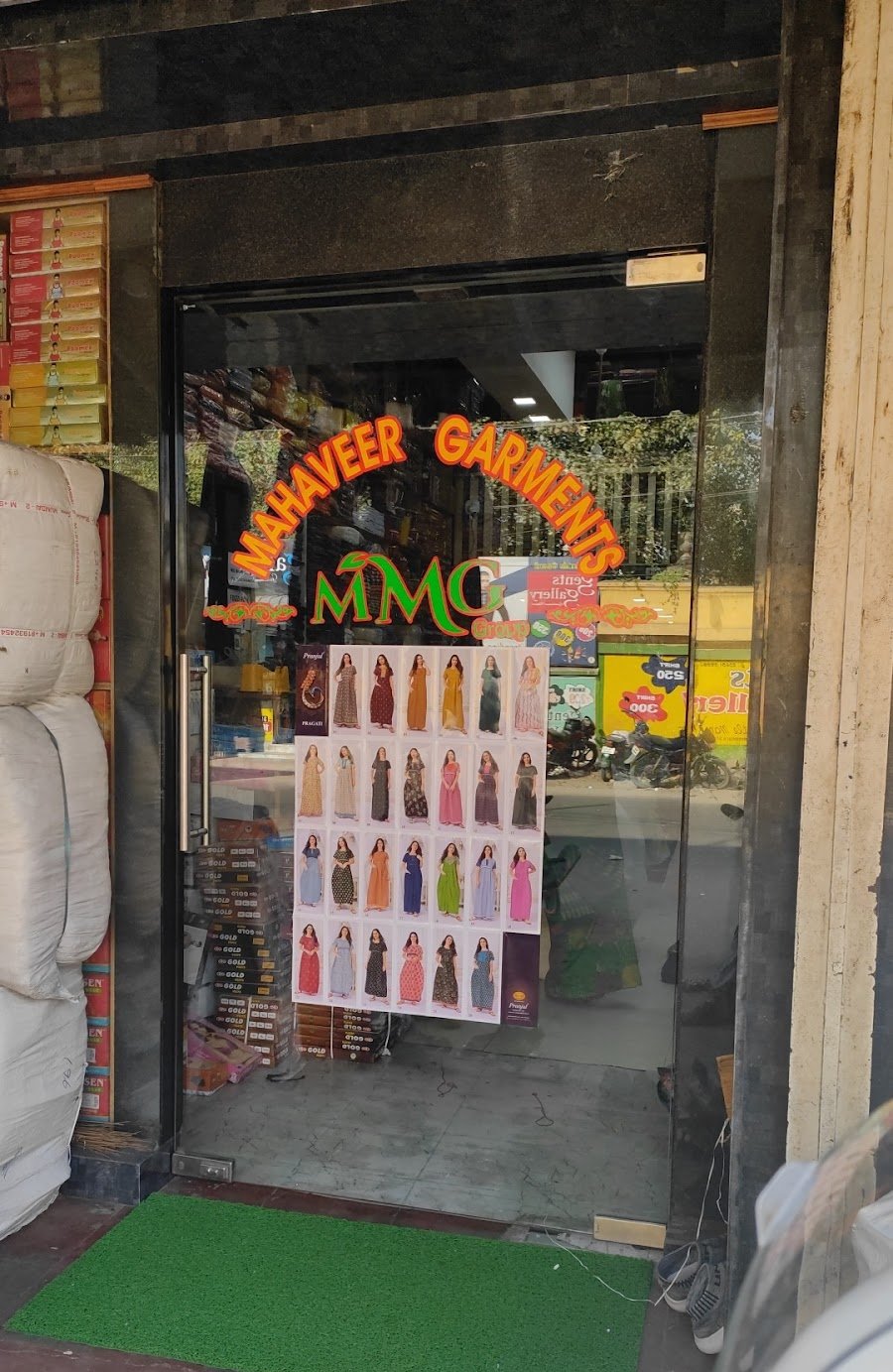 Glass entrance of Mahaveer Garments wholesale store with brand signage